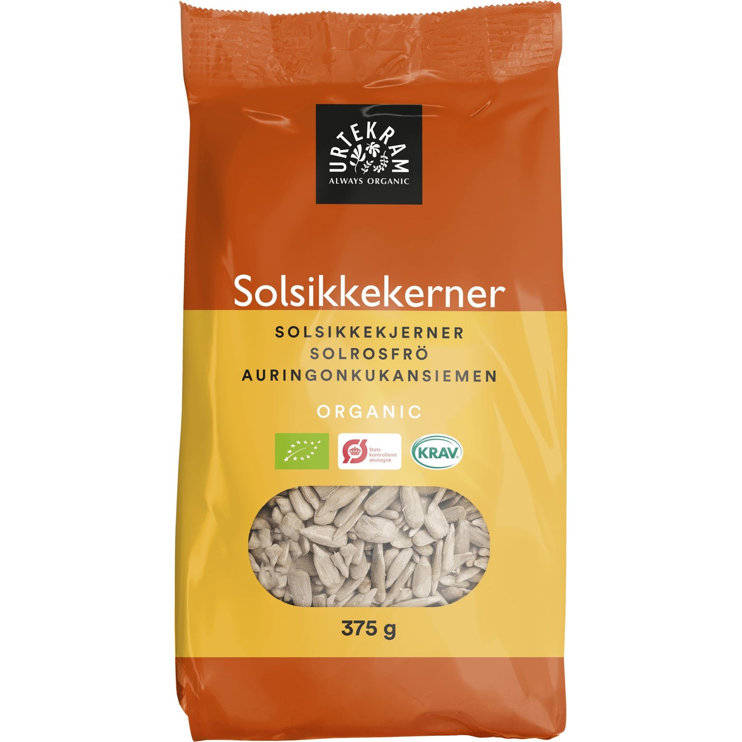 Urtekram Luomu Auringonkukansiemen, 375 g; usealla kielellä merkitty pakkaus läpinäkyvällä ikkunalla, josta siemenet näkyvät; pystyssä oleva, suorakulmainen pakkaus mattamuovia, väreinä akvaruskean ja kerman sävyt; brändinimi "Urtekram" lihavoidulla groteskifontilla yläosassa; vaalea tausta, ei ihmisiä tai käsiä.