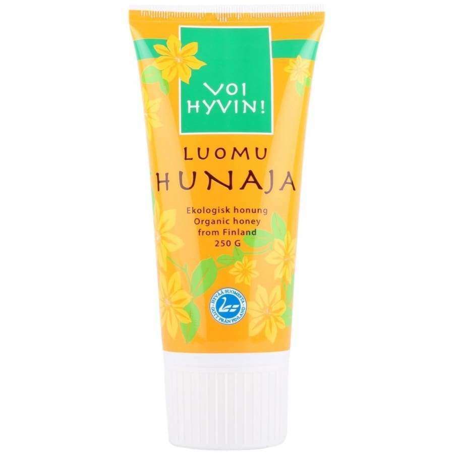 Voi Hyvin! Luomu Hunajatuubi, 250 g suomalaista luomuhunajaa; keltainen mattapintainen soikea muovituubi läppäkorkilla, kukkakuvitus ja lihavoitu groteskiteksti, teksti kolmella kielellä
