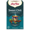 YogiTea Luomu Sweet Chili -pakkaus, turkoosi kultareunuksin, mattapintainen; koristeltu teekuppi, kanelitankoja, punaista chiliä ja kaakaopapuja kuvituksessa, 17 luomuteepussia