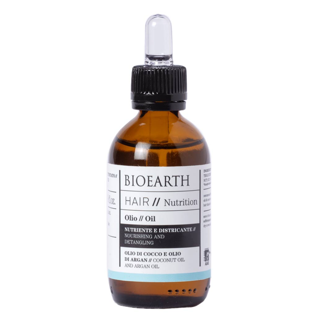 Bioearth HAIR 2.0 Hiusöljy kuiville hiuksille; ruskea, läpinäkyvä lasipullo mustalla tiputinkorkilla, sisällä näkyvä öljy; mattapintainen etiketti "Nutrition Oil" mustalla groteskitekstillä; sisältää kookos- ja arganöljyä hiusten kosteutukseen ja pehmentämiseen; valkoinen tausta.