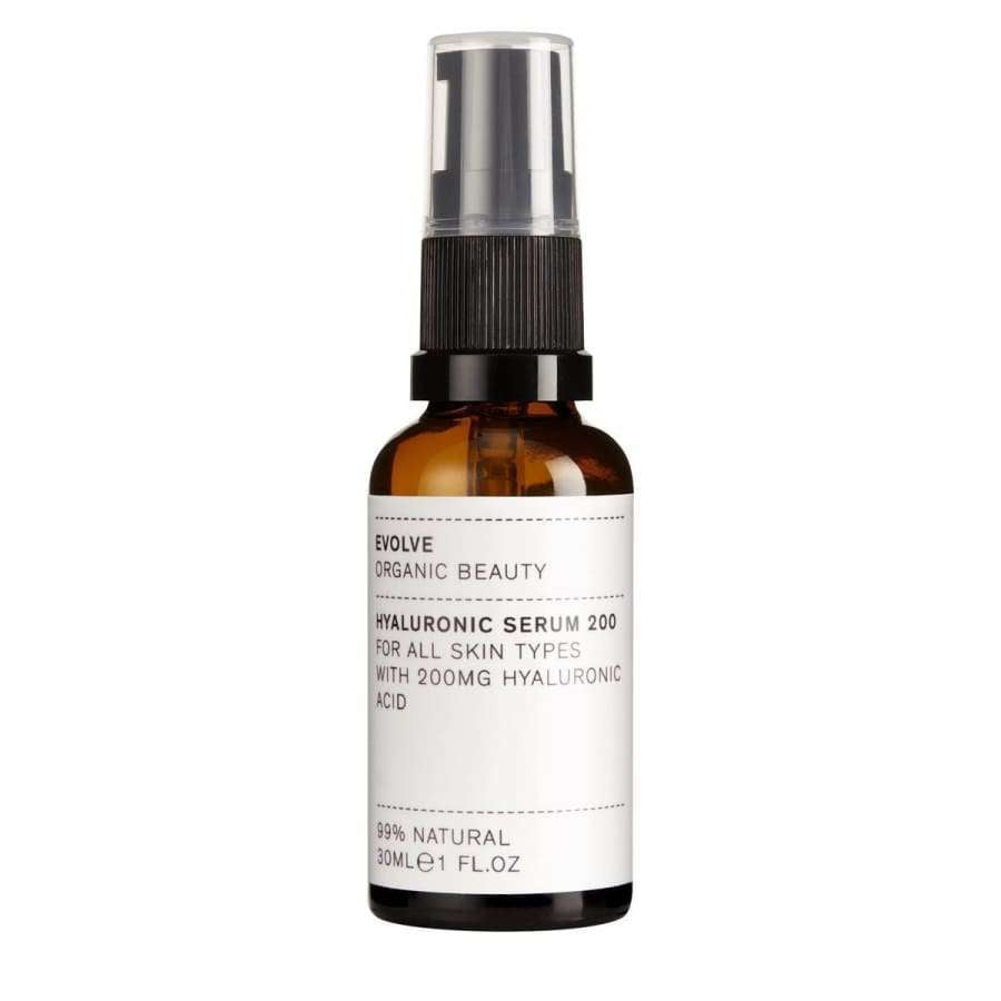 Evolve Hyaluronihapposeerumi -pullo, 30 ml; pieni, meripihkanvärinen ja sylinterimäinen pullo mustalla pumpulla; valkoisessa paperietiketissä yksinkertaista tekstausvapaata tekstiä 200 mg:n hyaluronihappopitoisuudesta ja 99-prosenttisesta luonnollisuudesta; pullo kuvattu pystyssä vaaleaa taustaa vasten, ei ihmisiä näkyvissä.