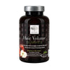 Hair Volume Gummies -pullo, New Nordicin tuote; tumma läpinäkymätön muovipullo kiiltäväpinnalla, painettuja kuvia omenoista; etiketissä ilmoitettu 60 kumipurutablettia yrtti- ja biotiiniainesosin hiusten tueksi; typografia lihavoitua tekstausvapaata valkoista ja vihreää fonttia; ei ihmisiä tai käsiä näkyvissä; tuote kuvattu yksinään vaaleaa taustaa vasten.