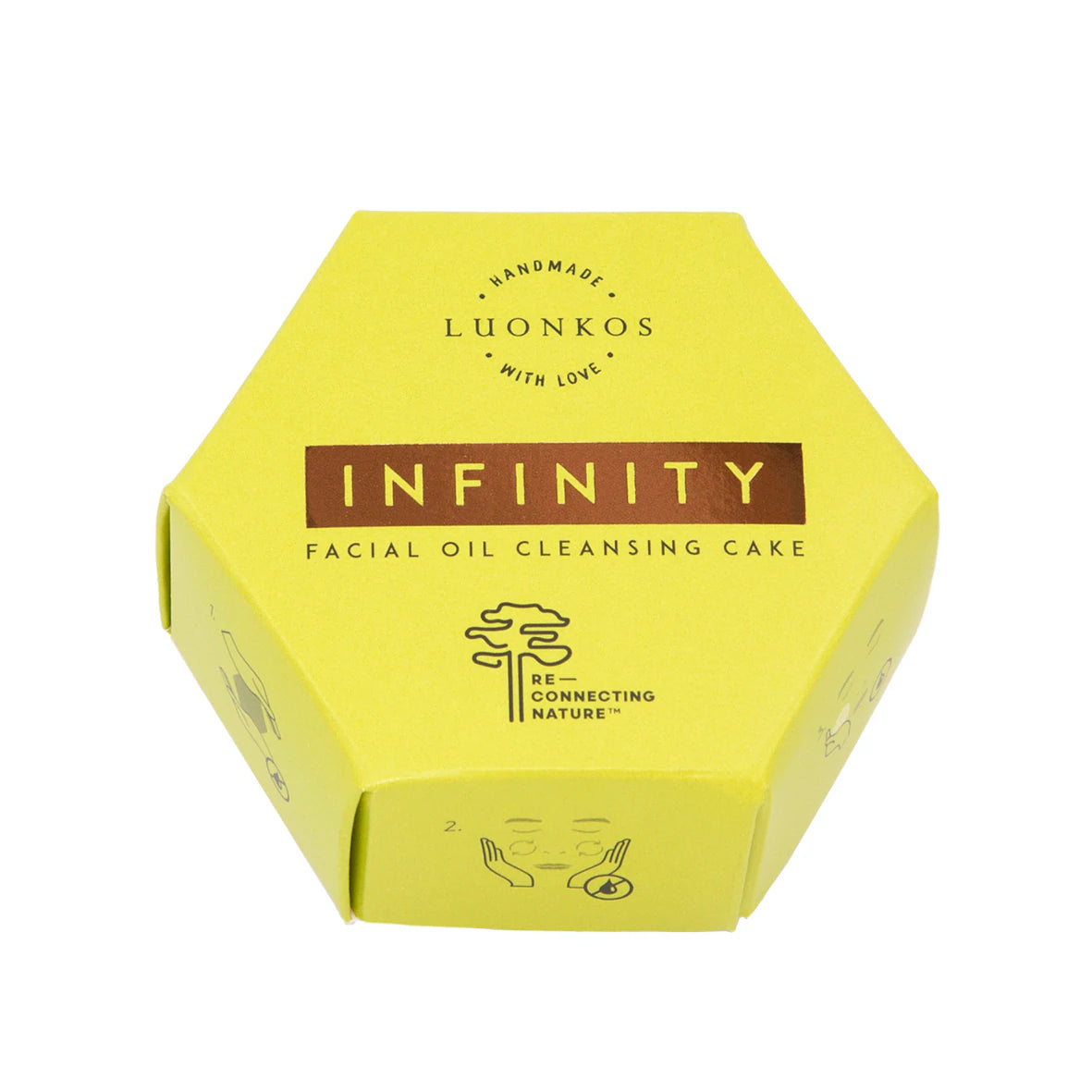 Luonkos INFINITY Öljypuhdistuskakku; keltainen kuusikulmainen rasia tekstillä "LUONKOS INFINITY Facial Oil Cleansing Cake", kasvikuvakkeineen ja Reconnecting Nature -logoineen etuosassa; rasian materiaali vaikuttaa mattapintaiselta pahvilta; typografia lihavoitua ja groteskia tuotenimelle; vaalea tausta ilman rekvisiittaa tai ihmisiä; kuva otettu suoraan edestä silmän tasolta, keskitettynä kuvaan.