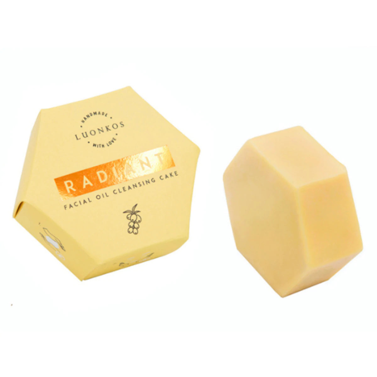 LUONKOS Radiant Facial Oil Cleansing Cake -laatikko, keltainen kuusikulmainen laatikko vastaavan kiinteän beigen öljypuhdistuspalan vieressä; molemmilla mattapinta; laatikossa mustaa suuraakkosista typografiaa yksinkertaisella tekstausvapaalla fontilla; öljypuhdistuspala myös kuusikulmainen; tausta vaalea ja yksinkertainen, ei rekvisiittaa tai ihmisiä näkyvissä.