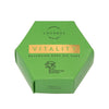 Luonkos VITALITY Vartaloöljykakku; vihreä, mattapintainen kuusikulmainen pahvirasia tekstillä "VITALITY Balancing Body Oil Cake" by Luonkos; pakkauksessa kultaista tekstiä ja puulogo, luettavissa "Handmade with love" ja "VEGAN ORGANIC"; kaikki sivut näkyvissä; ei ihmisiä tai käsiä; vaalea tausta; vegaaninen koostumus tasapainottaa ihoa öljykakkuna.