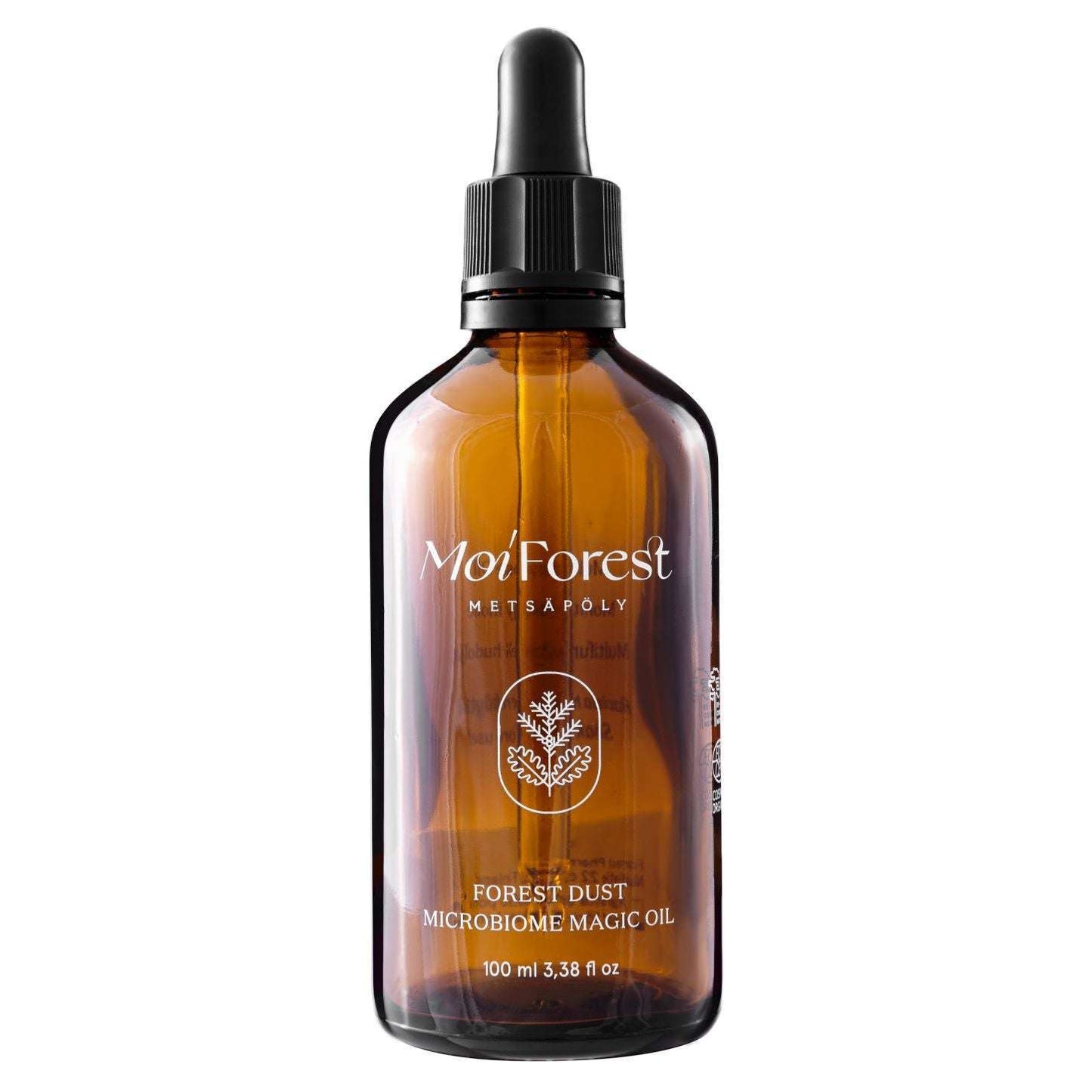 Moi Forest Dust Microbiome Magic Oil; ruskea lasinen pipettipullo tekstillä "Moi Forest Forest Dust Microbiome Magic Oil", 100 ml; pullossa musta muovinen pipettikorkki ja mattapintainen etiketti yksinkertaisin valkoisin puukuvituksin; typografia groteskia valkoisena ja vihreänä ruskeaa lasia vasten; ei ihmisiä tai käsiä kuvassa, pelkistetty tausta, tavanomainen tuotekuvakulma.