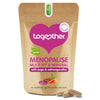 Together Health Menopause; ruskea mattapintainen joustopussi pystyssä tekstillä "Together Menopause Multi Vit & Mineral with sage & ashwagandha" selkeällä groteskikirjasimella; teksti mainitsee adaptogeeniset yrtit ja mahalle lempeyden; kaksi beigeä kapselia tasaisella alustalla pussin edessä; neutraali tausta, ei ihmisiä tai käsiä kuvassa.