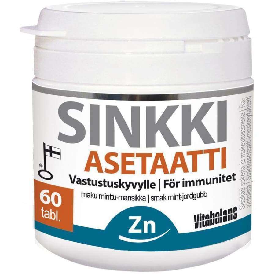 Vitabalans Sinkkiasetaatti -purkki, 60 tablettia; valkoinen, mattapintainen ja sylinterimäinen muovipurkki kierrekannella; suomen- ja ruotsinkielinen teksti immuniteetin tuesta; oranssissa etiketissä sininen "Zn"-symboli ja merkintä "60 tabl." selkeällä tekstausvapaalla kirjasimella; kuvattu valkoista taustaa vasten ilman ihmisiä tai muita esineitä.