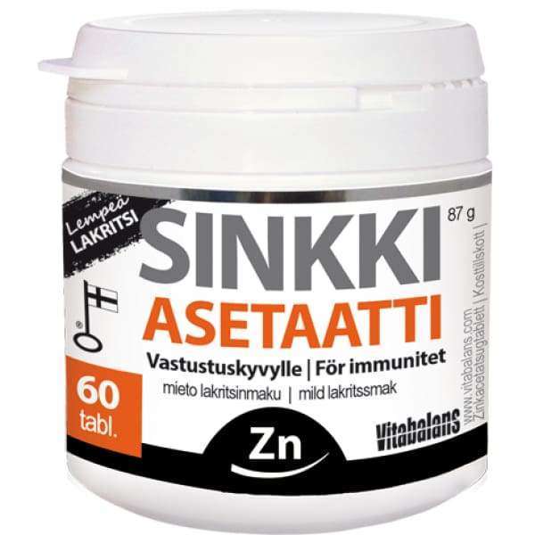 Vitabalans Sinkki Asetaatti, 60 tabl., lempeä lakritsin makuinen; valkoinen, mattapintainen, lieriömäinen muovipurkki ja kierrekorkki; etiketissä lihavoitu musta "Zn"-symboli, suomen- ja englanninkielistä tekstiä sekä brändinimi "Vitabalans"; tuote kuvattu yksin vaalealla taustalla.