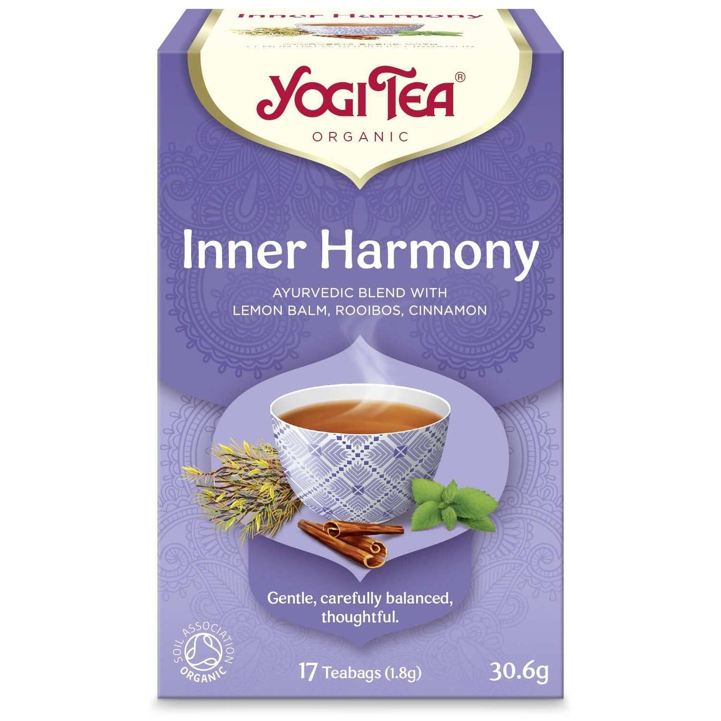 YogiTea Luomu Inner Harmony -teepakkaus; suorakulmainen, mattapintainen ja violetti rasia; kuvituksena teekuppi, sitruunamelissa, rooibos-oksia ja kanelitankoja; valkoista ja keltaista koristeellista tekstiä; pakkaus kuvataan luomu-ayurvedisena teeseoksena; ei ihmisiä tai ympäristöä näkyvissä.